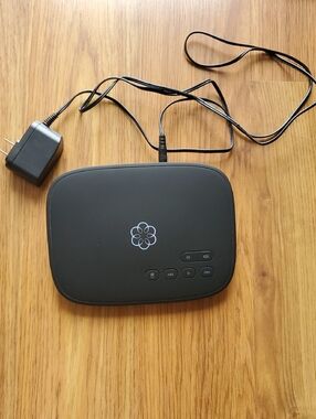 Ooma Telo VoIP Adapter with White Logo on Black Panel